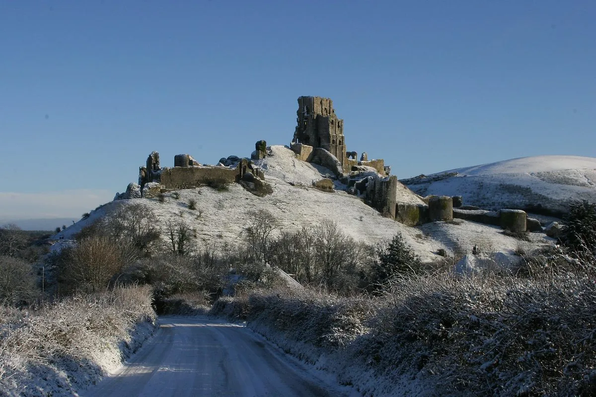 Corfe Castle in snow, viewed from across the village
