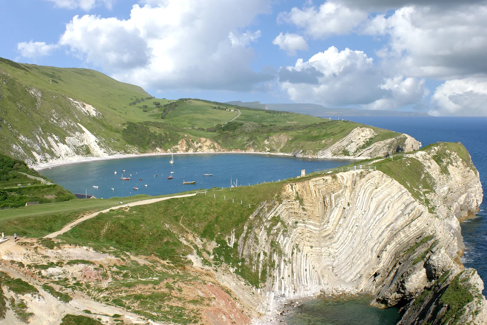 Elevated view of Lulworth Cove showing its circular shape and folded chalk cliffs