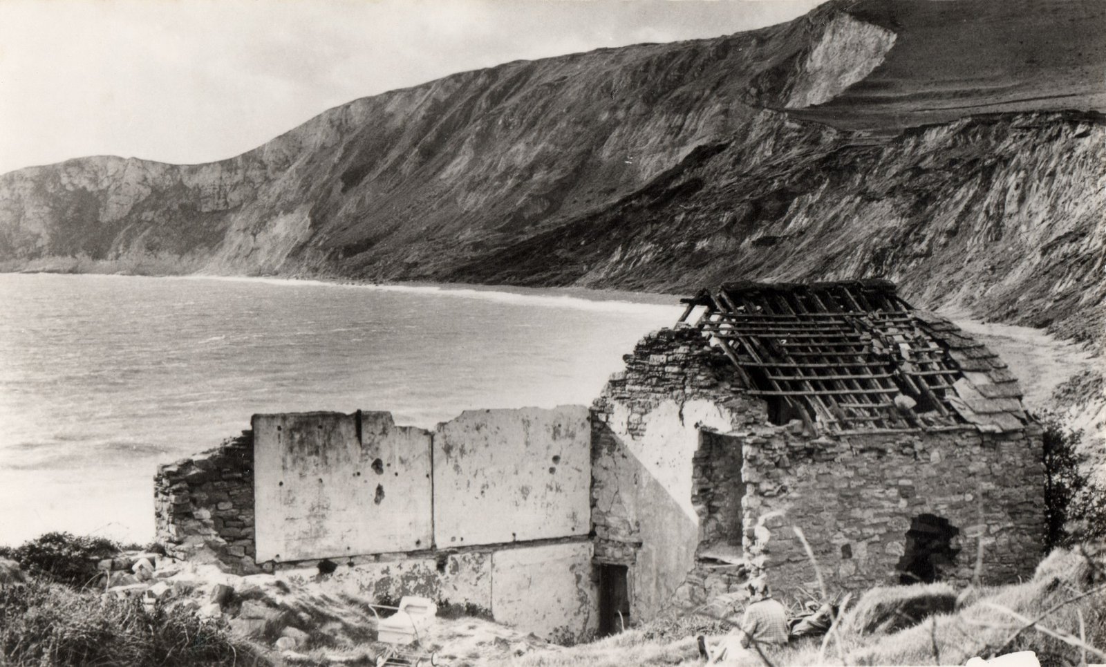 The ruined cottages of Worbarrow hamlet after the evacuation, with the bay behind