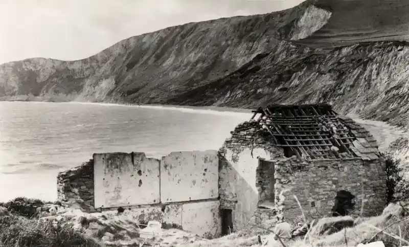 The ruined cottages of Worbarrow hamlet after the evacuation, with the bay behind